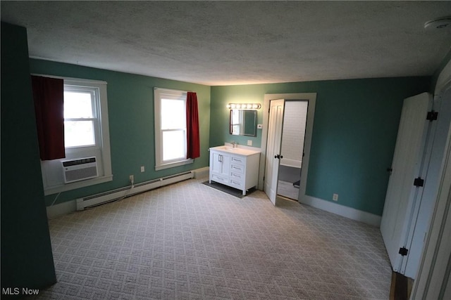 unfurnished bedroom with a textured ceiling, light colored carpet, baseboard heating, and a wall unit AC