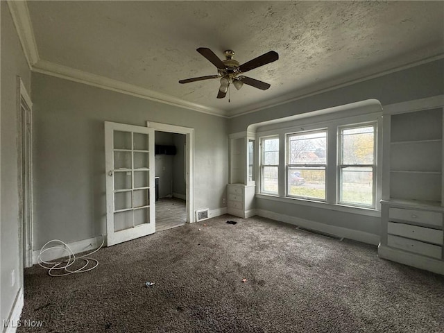 unfurnished bedroom featuring carpet flooring, ceiling fan, a textured ceiling, and ornamental molding