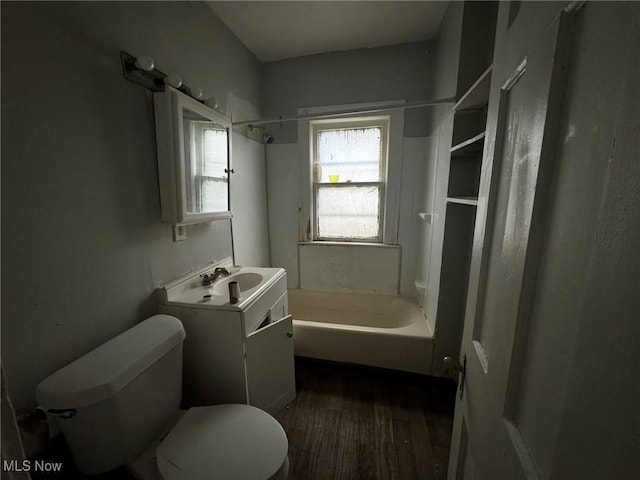 full bathroom with vanity, toilet, wood-type flooring, and shower / tub combination