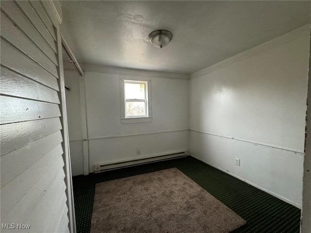 carpeted empty room with baseboard heating