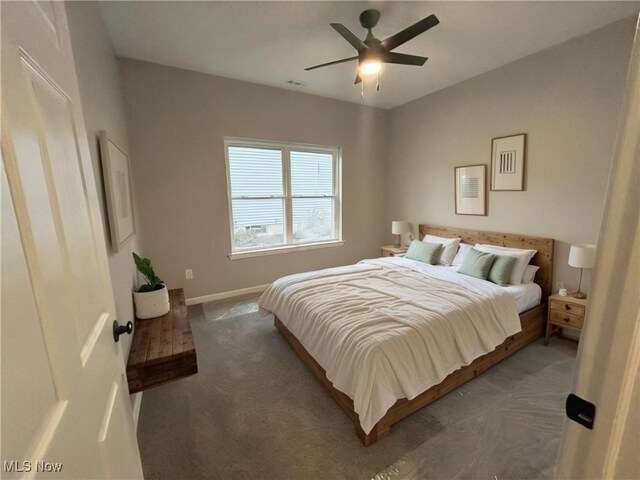 bedroom with ceiling fan and dark carpet