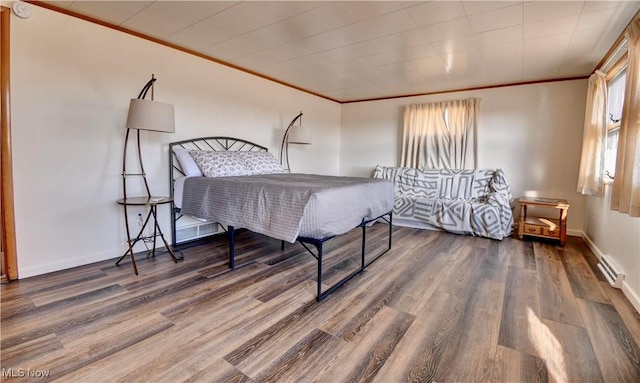 bedroom with dark hardwood / wood-style floors and crown molding