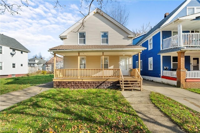 view of front of house featuring covered porch and a front yard