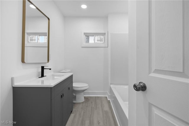 bathroom featuring hardwood / wood-style floors, vanity, and toilet