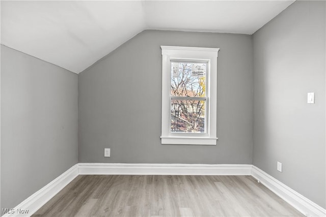 bonus room with light hardwood / wood-style flooring and lofted ceiling