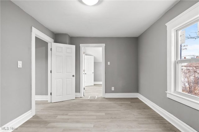 unfurnished room with light wood-type flooring