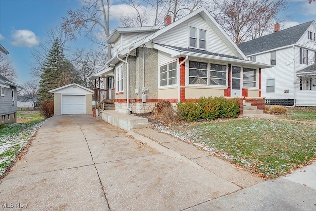 view of front facade with a sunroom, a garage, and an outbuilding