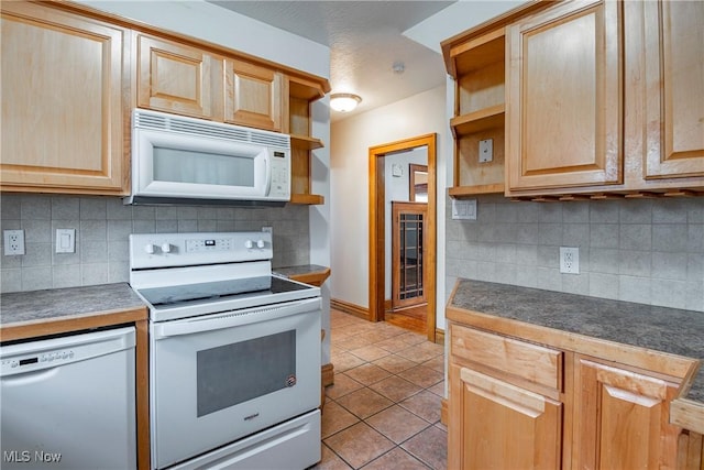 kitchen featuring decorative backsplash, light tile patterned floors, white appliances, and light brown cabinetry