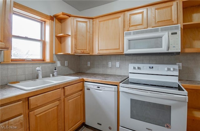 kitchen featuring light brown cabinetry, white appliances, tasteful backsplash, and sink