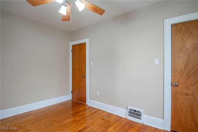 empty room with light hardwood / wood-style floors and ceiling fan