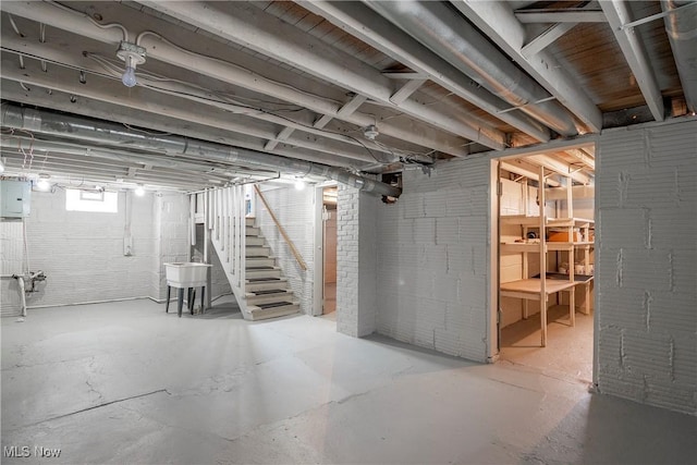 basement with sink and electric panel