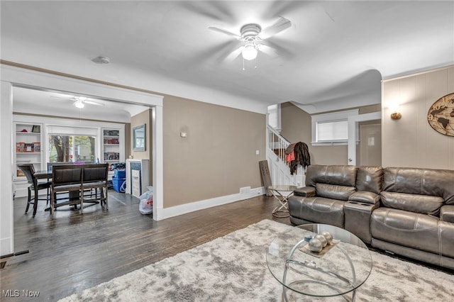 living room featuring dark hardwood / wood-style floors and ceiling fan