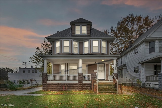 victorian house with covered porch and a lawn