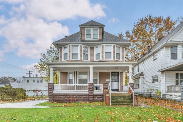 victorian house with covered porch and a front lawn