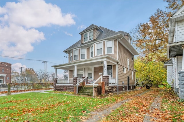 view of front of property featuring a front yard and a porch