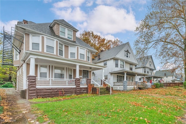 view of front of house with a porch and a front lawn