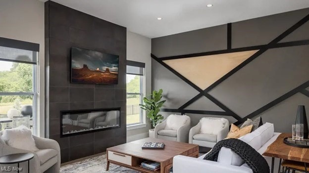 living room featuring a tile fireplace