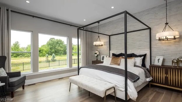 bedroom with hardwood / wood-style floors