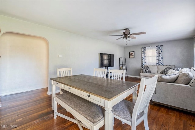 dining space featuring ceiling fan and dark hardwood / wood-style flooring