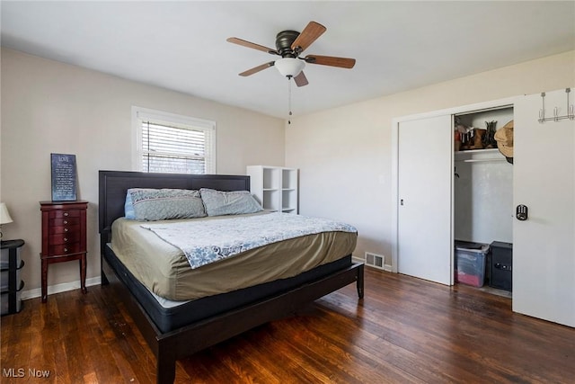 bedroom with ceiling fan, dark hardwood / wood-style flooring, and a closet