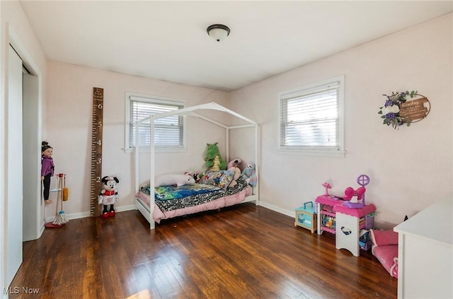 bedroom with dark hardwood / wood-style floors