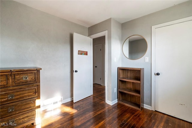 unfurnished bedroom with dark hardwood / wood-style floors