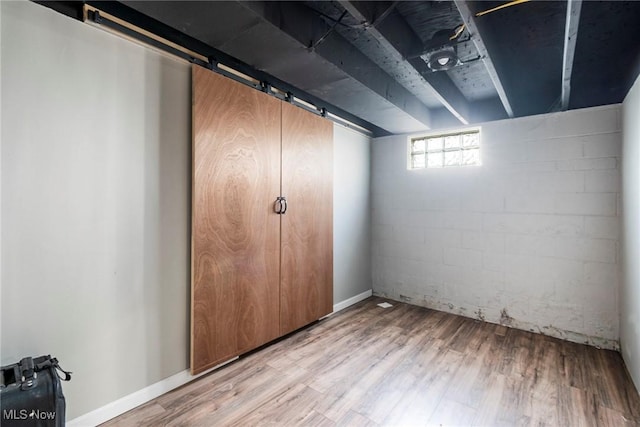 basement with hardwood / wood-style flooring