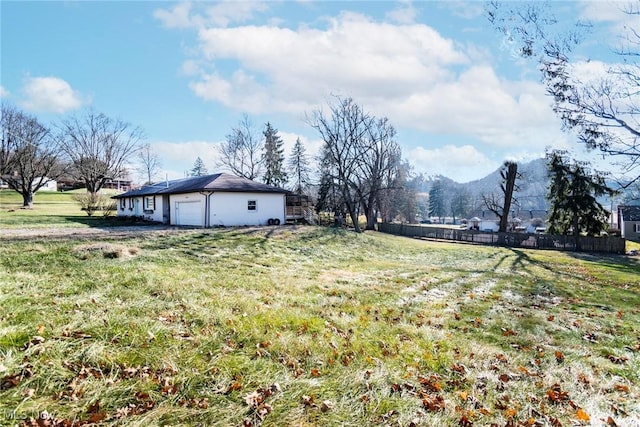 view of yard featuring a mountain view and a garage