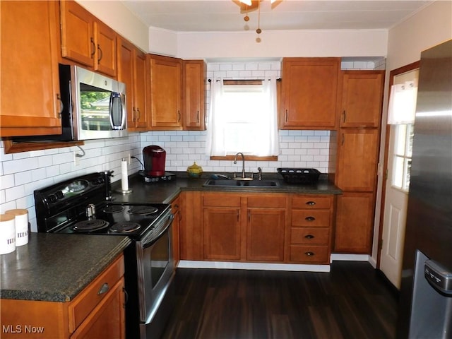 kitchen featuring dark hardwood / wood-style flooring, sink, plenty of natural light, and appliances with stainless steel finishes