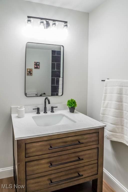 bathroom featuring hardwood / wood-style floors, vanity, and toilet