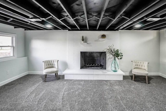 unfurnished room featuring carpet flooring and a tile fireplace