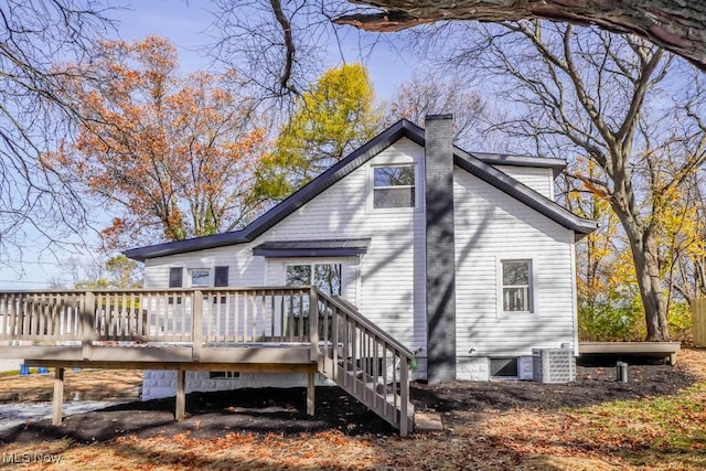 back of property featuring a deck and cooling unit