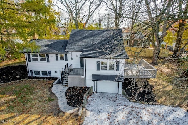 view of front of property featuring a deck and a garage