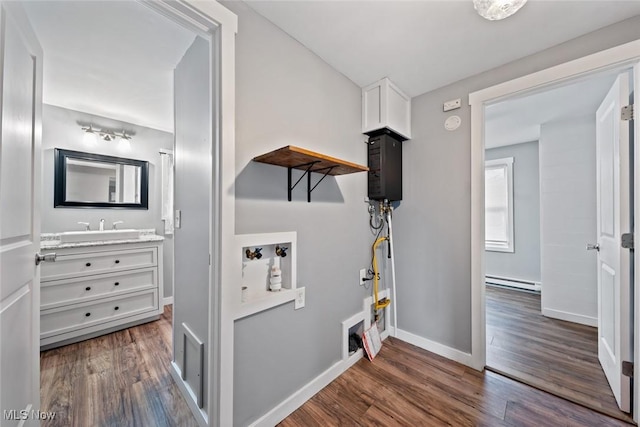 laundry room with baseboard heating and dark wood-type flooring