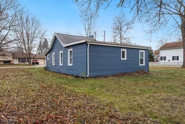 view of side of home with a lawn