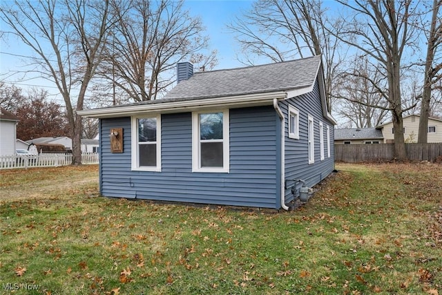 view of side of home featuring a lawn