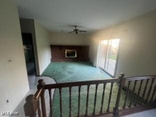 stairway with carpet flooring and ceiling fan