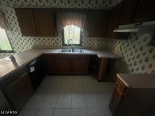 kitchen featuring light tile patterned flooring and sink