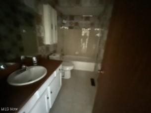 full bathroom featuring vanity, shower / bath combination, and toilet