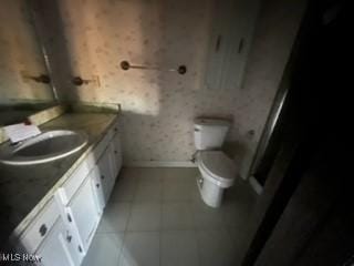 bathroom featuring tile patterned floors, vanity, and toilet