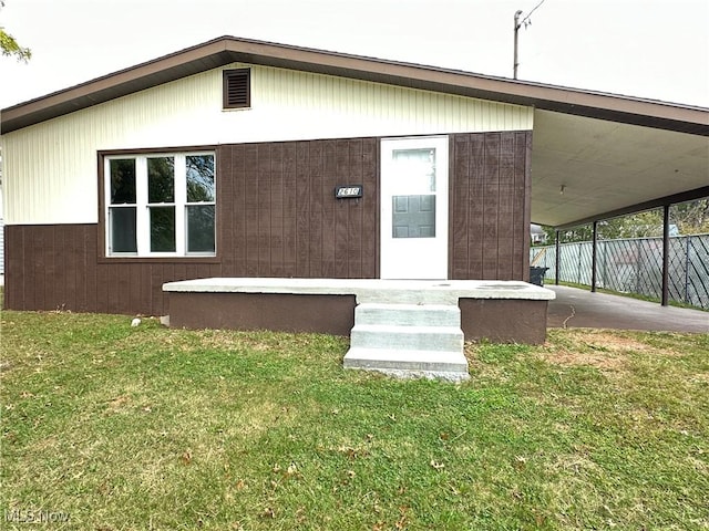 rear view of house with a lawn