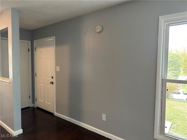 foyer with dark hardwood / wood-style floors and a textured ceiling