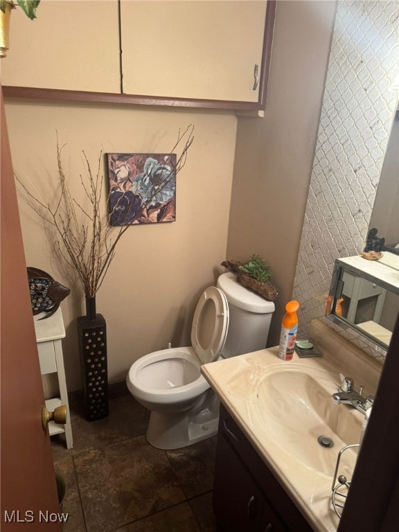 bathroom with toilet and vanity