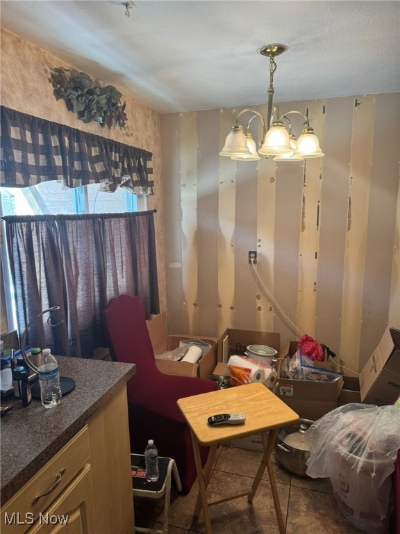 tiled dining area with a notable chandelier