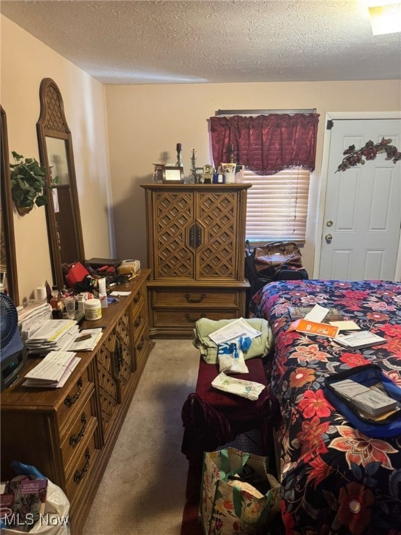 bedroom with a textured ceiling and carpet floors