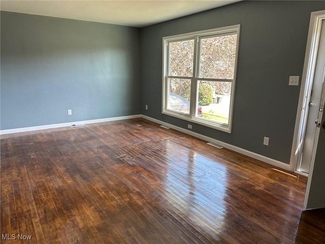 spare room featuring dark hardwood / wood-style flooring