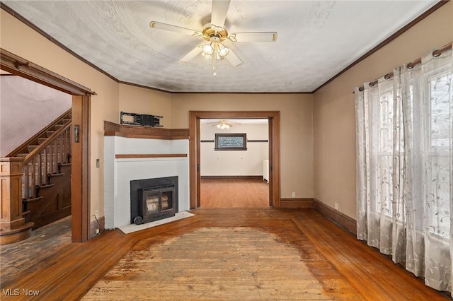 unfurnished living room featuring hardwood / wood-style floors, ceiling fan, and ornamental molding