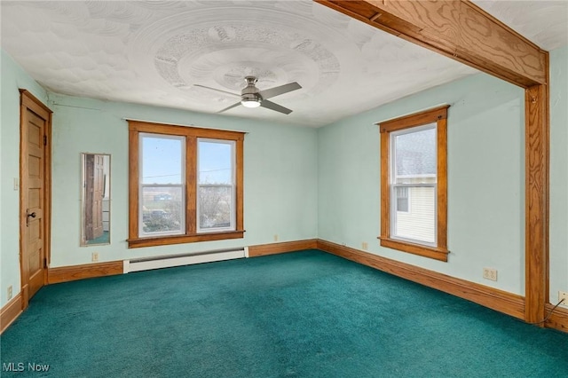 carpeted spare room featuring ceiling fan and baseboard heating