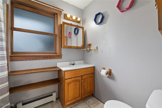 bathroom with tile patterned flooring, vanity, toilet, and a baseboard heating unit