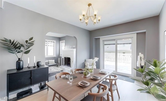 dining room with a notable chandelier and light wood-type flooring